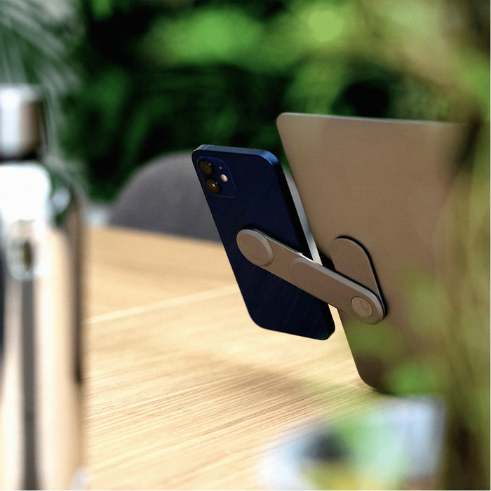 EDGE® Full Kit - Productivity magnetic kit - Carrara White - Basalt grey magnetic phone mount holding smartphone on wooden desk next to laptop and silver bottle. - Rolling Square