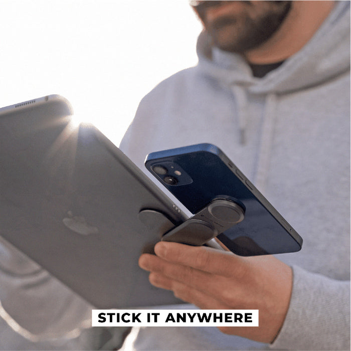 EDGE® Full Kit - Productivity magnetic kit - Carrara White - Black magnetic phone grip attached to the back of a blue smartphone held by a person in a gray hoodie. - Rolling Square