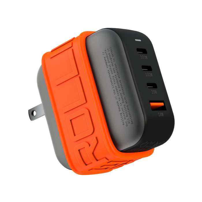 Essential GaN Charger - 100W power, 45% smaller - US - Compact black GaN charger with three USB ports and bright orange protective sleeve. - Rolling Square