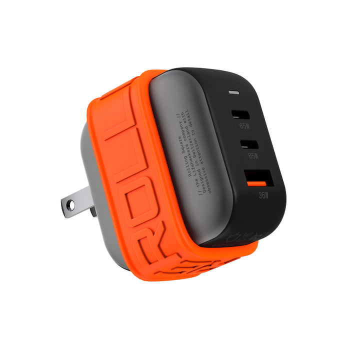 Essential GaN Charger - 65W power, 45% smaller - US - Compact black GaN charger with orange silicone protective sleeve and dual USB-C and one USB-A ports. - Rolling Square