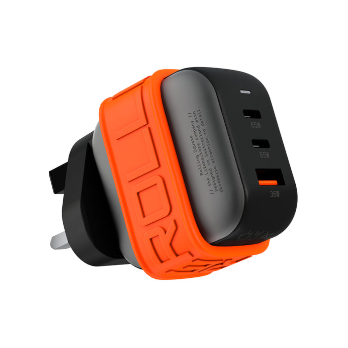 Essential GaN Charger - 65W power, 45% smaller - US - Compact black GaN charger with three USB ports and an orange silicone protective sleeve. - Rolling Square