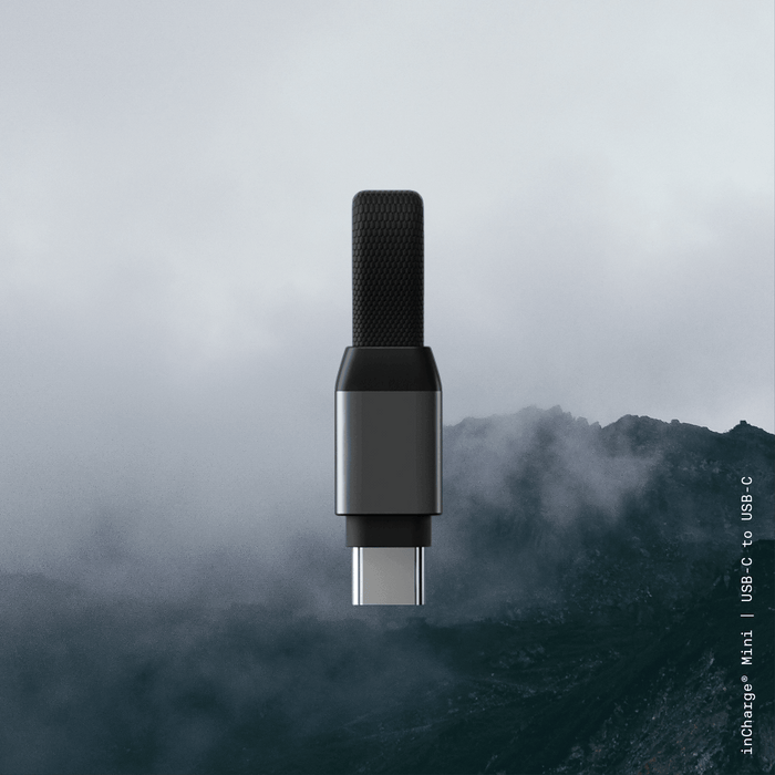 inCharge® Mini - The Smallest cable ever - USB to Lightning - Compact black USB-C to USB-C charging cable with textured grip on dark foggy mountain background. - Rolling Square